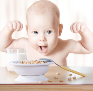 Happy baby meal: cereal and milk. Concept: healthy food makes child strong and health
