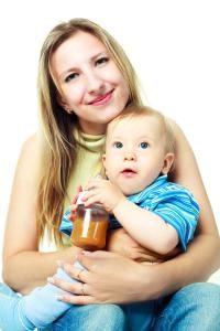 baby drinking juice with mom